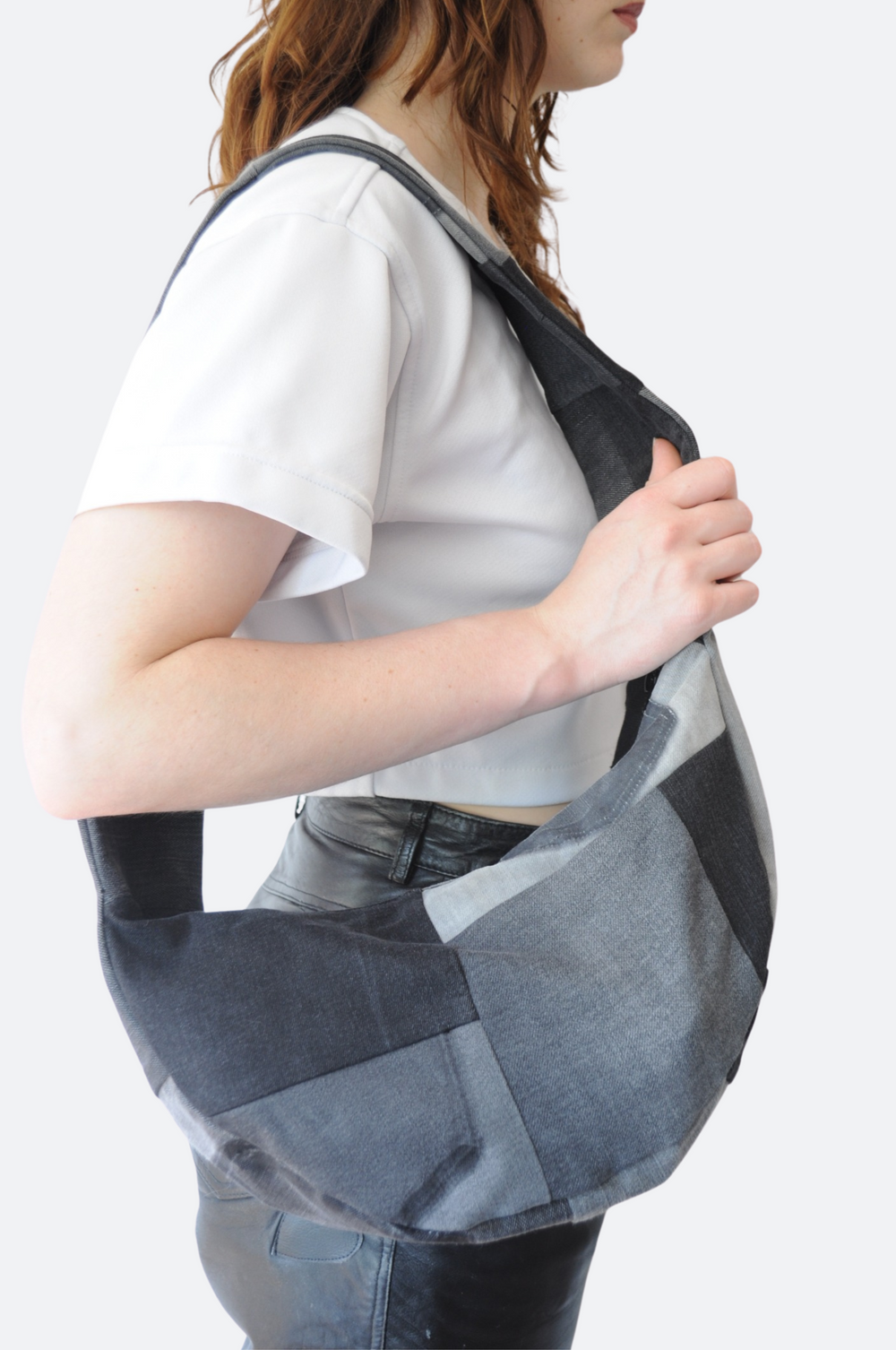 Zijkant Handgemaakte schoudertas van zwart-grijs patchwork denim, upcycled en gevoerd met reststof – uniek ontwerp uit Rotterdam - Sevaes